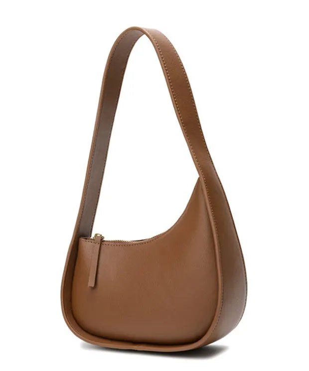 Small half moon shaped women's leather shoulder bag with a wide strap and soft handle.