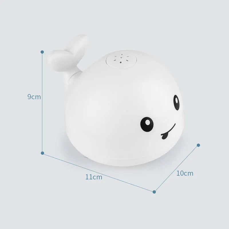 Electric whale bath toy with automatic water spray and flashing lights on a base