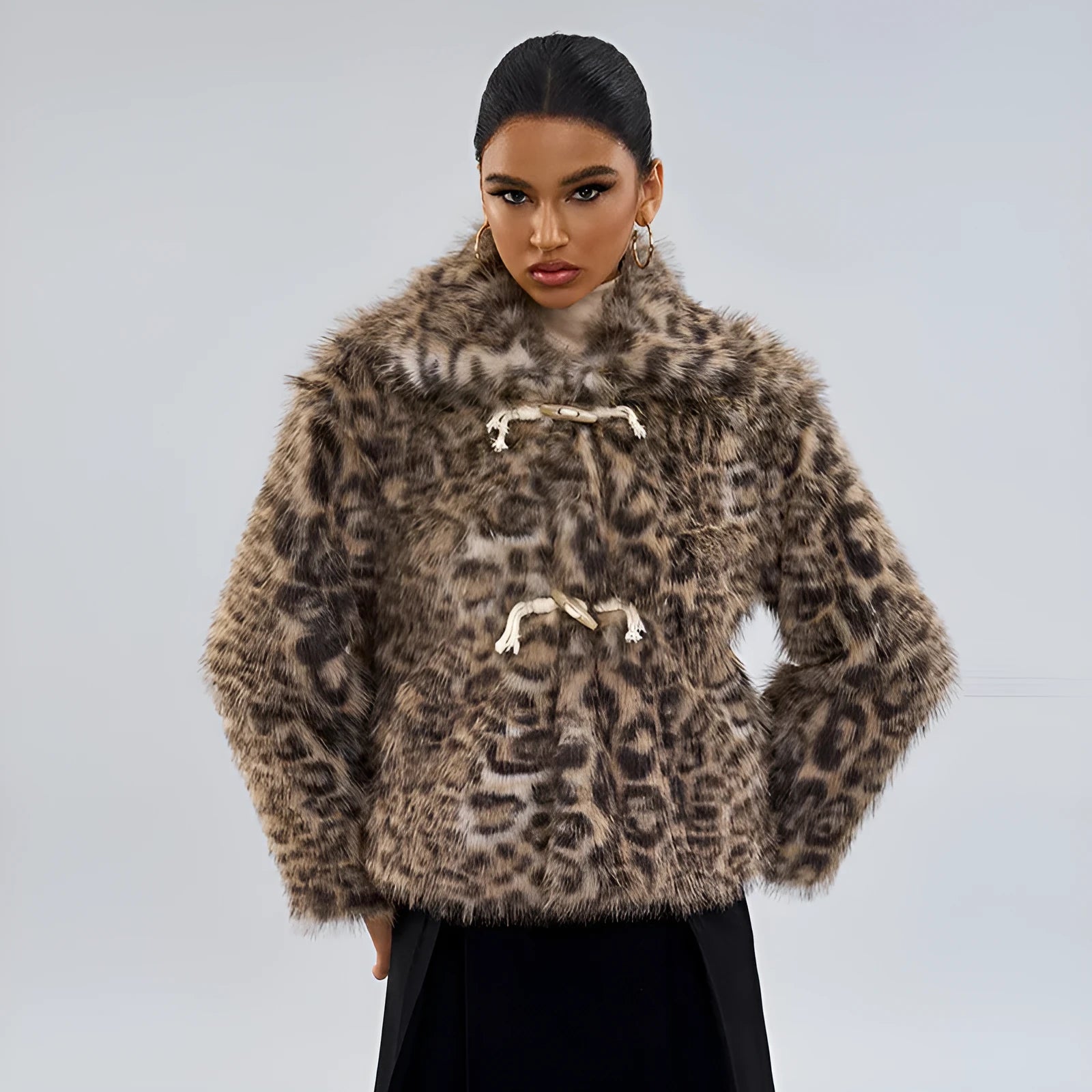 Women's leopard print coat with buckle lapel closure showing regular sleeves and normal length