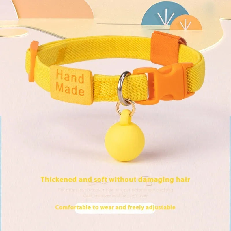 Small dog's elastic polyester collar in a solid colour with a buckle, showing the adjustable length.
