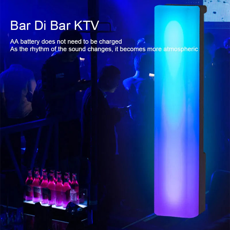 Black and white 3D RGB voice-activated music rhythm ambiance lamp on a table.