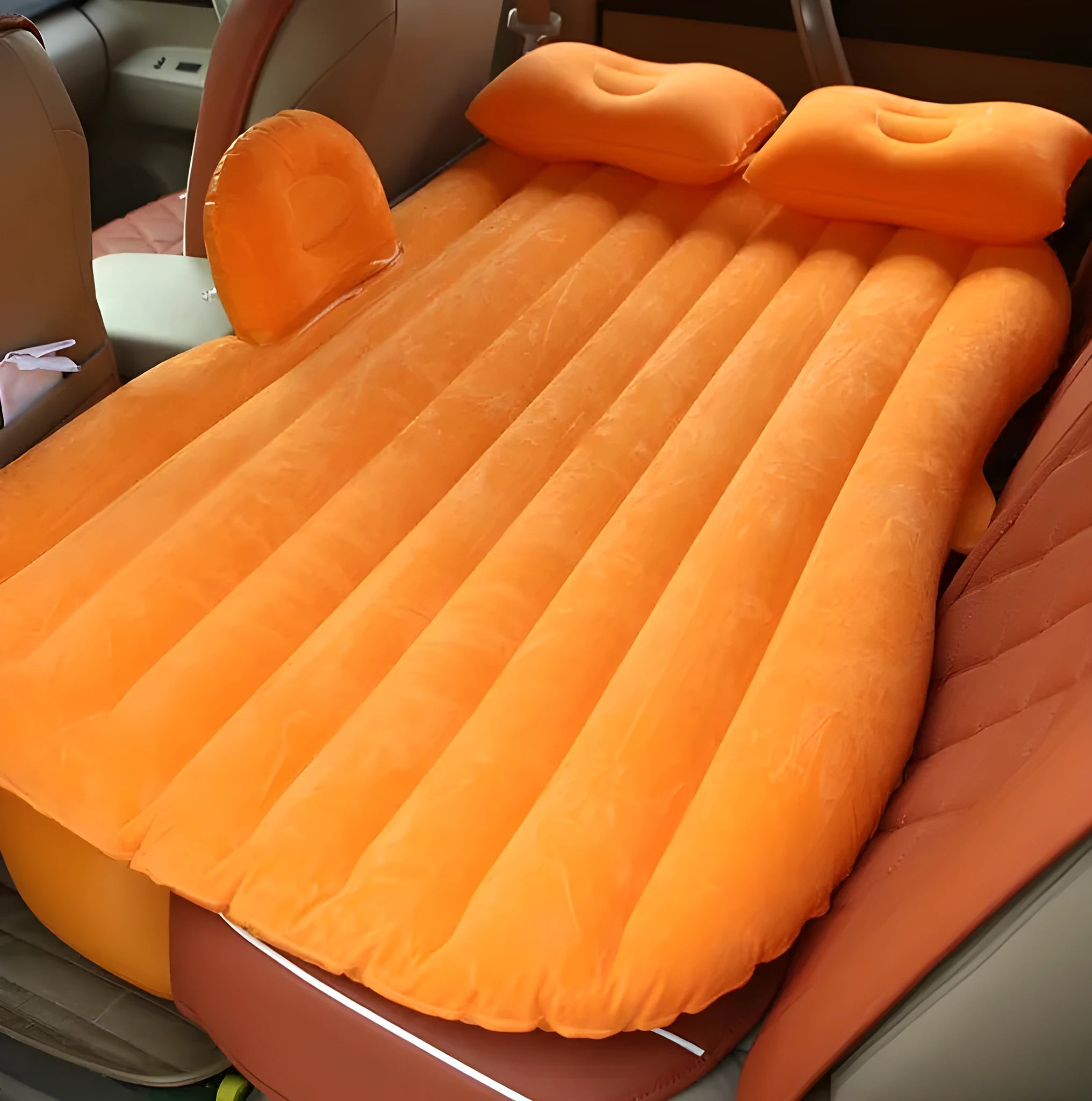 Black inflatable car bed with flocked surface, two pillows, and storage bag for five-seater vehicles
