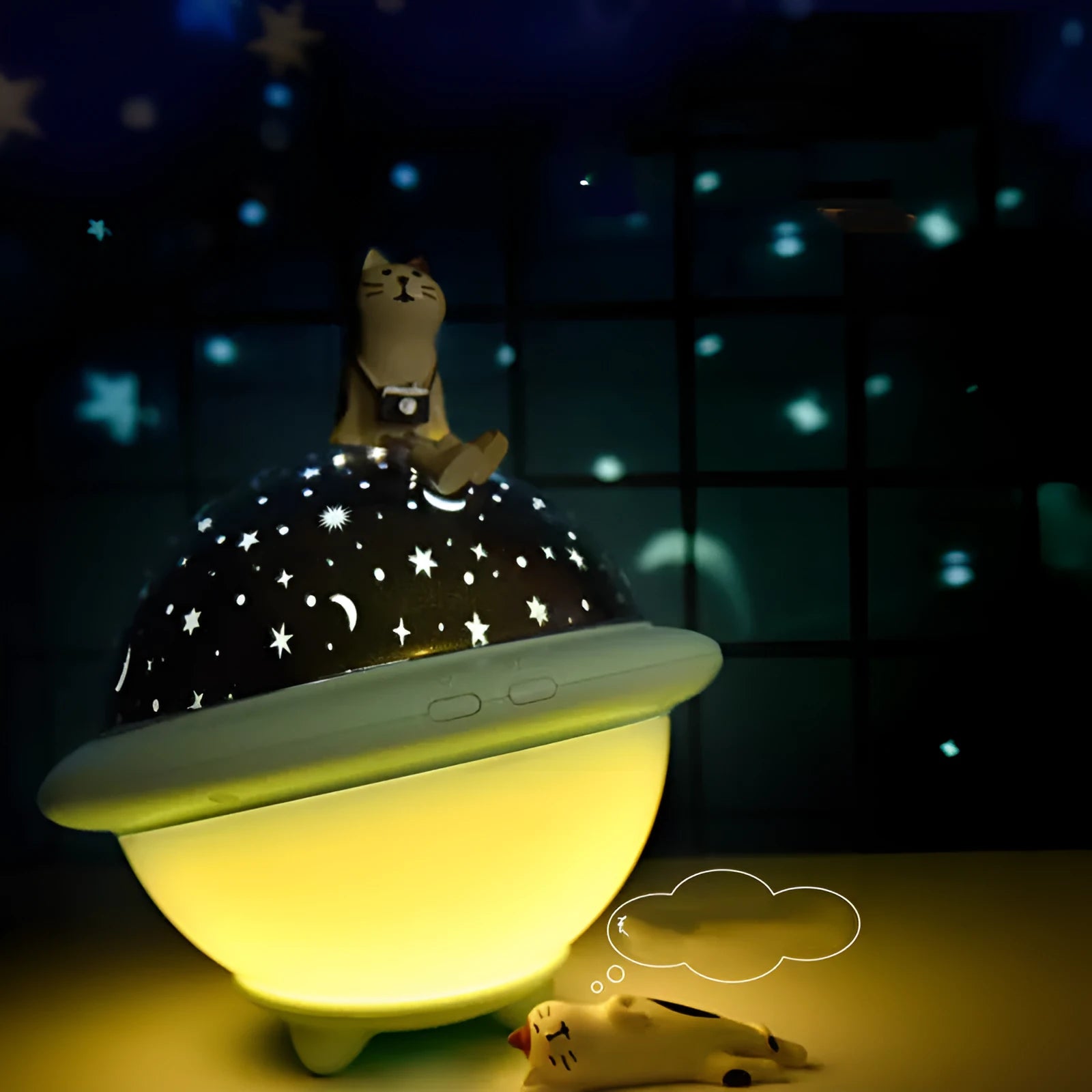 Green UFO-shaped plastic LED night light projecting starry sky pattern on a dark wall