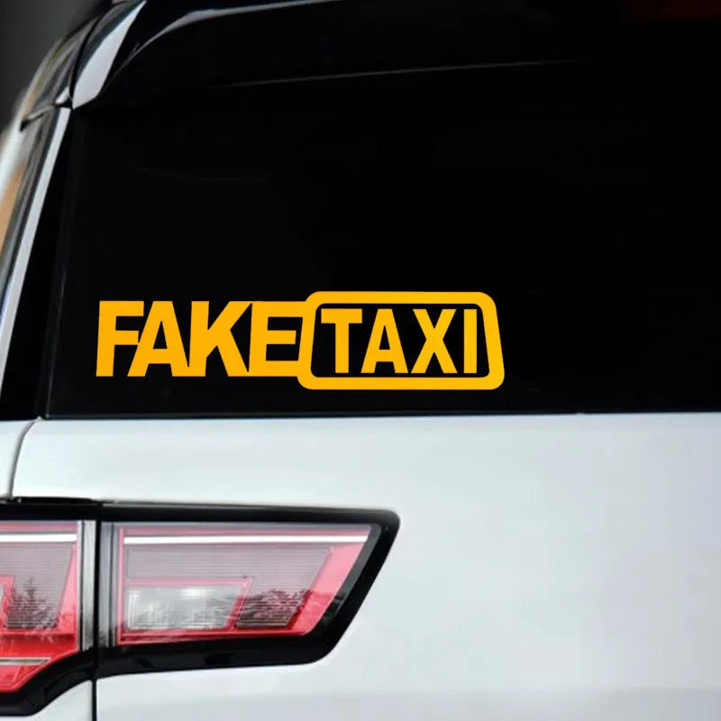 Waterproof FAKE TAXI car warning sticker in yellow, 20cm by 8cm, on a vehicle window.