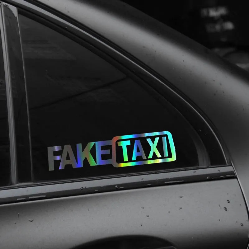 Waterproof FAKE TAXI car warning sticker in yellow, 20cm by 8cm, on a vehicle window.