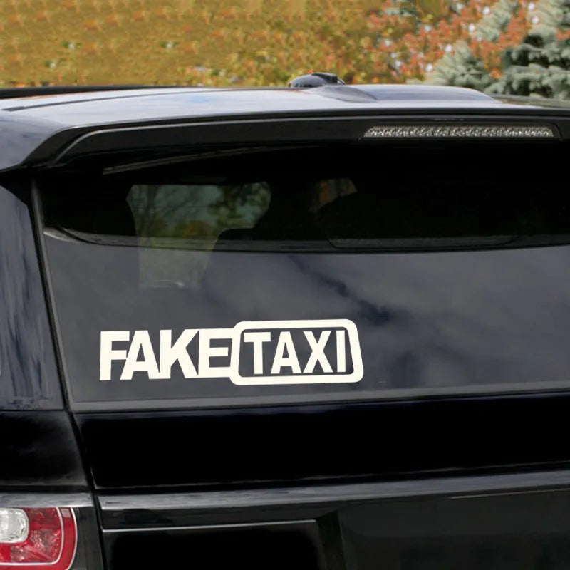 Waterproof FAKE TAXI car warning sticker in yellow, 20cm by 8cm, on a vehicle window.