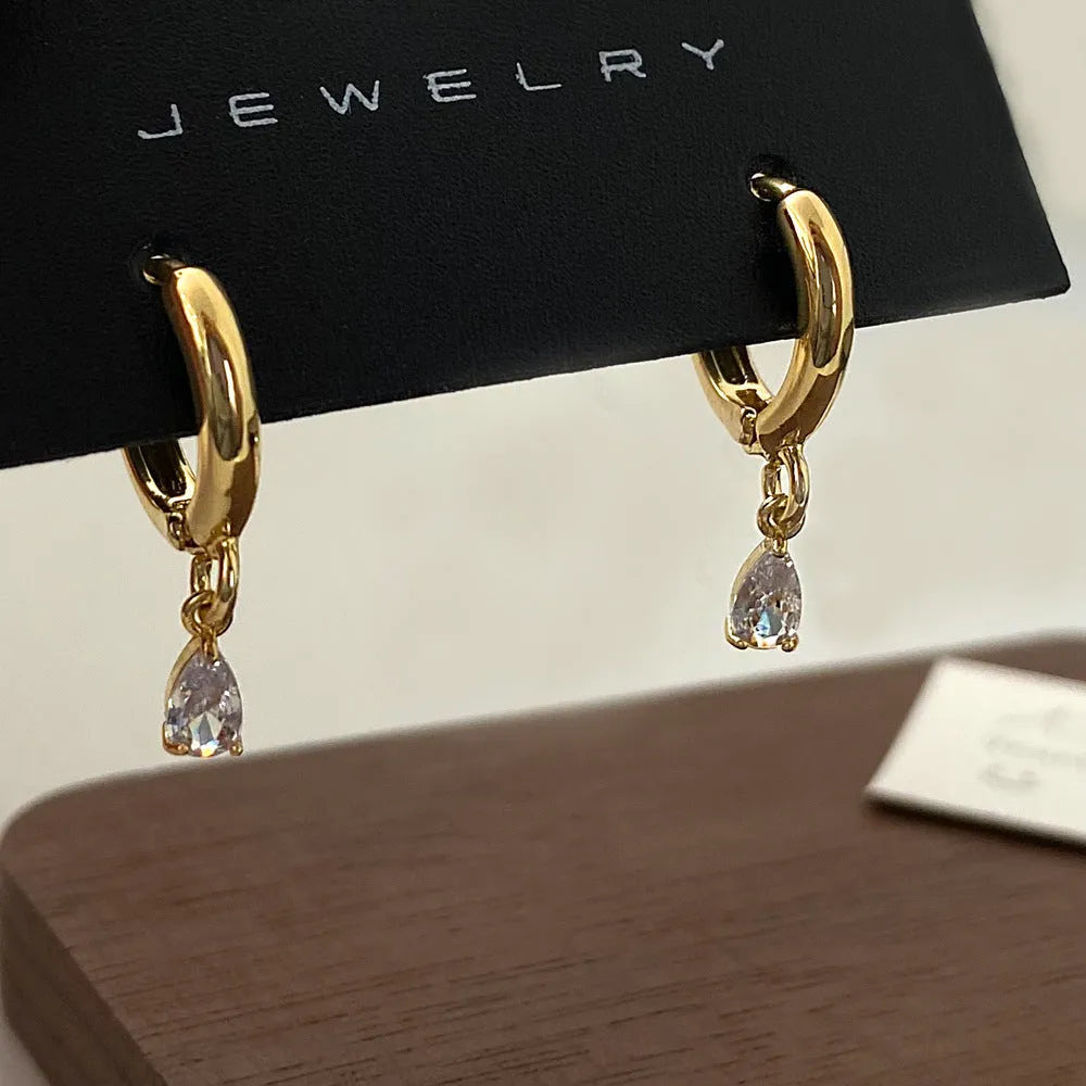 Women's zircon necklace, earrings, and anklet set with geometric pendant.