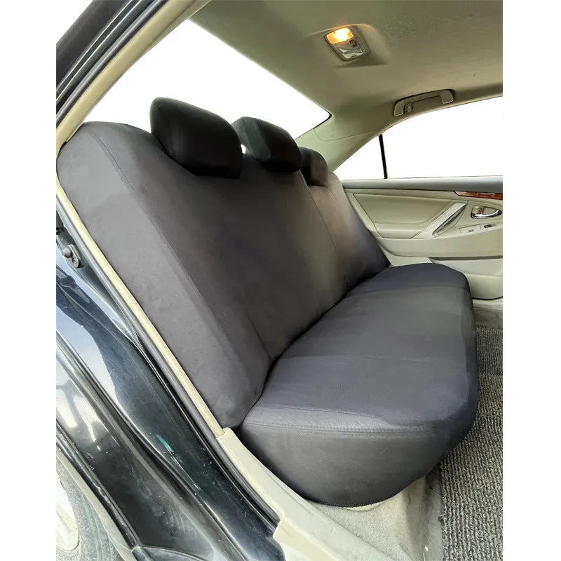 Universal polyester car seat cover set in blue showing headrest and seat panels with eyelet stitching.