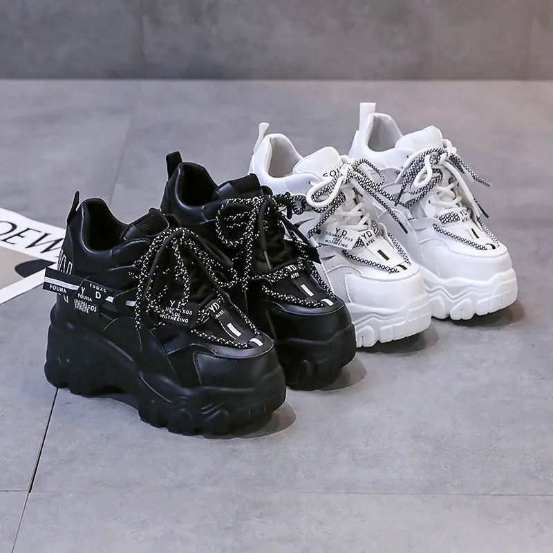Women's white breathable mesh platform sports shoe with a cross strap on a rubber sole