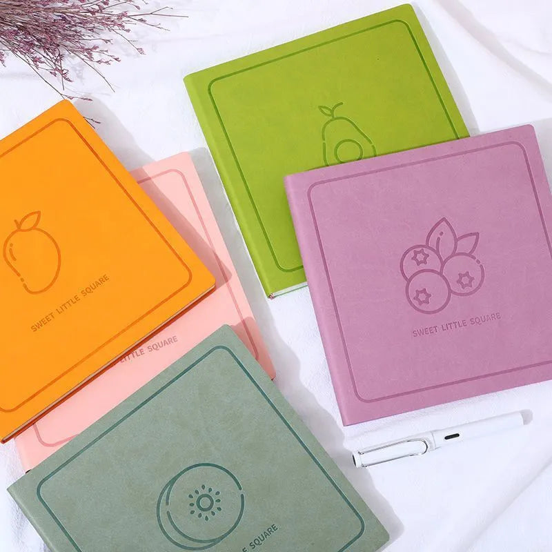 A5 square notebook with faux leather cover showing colour options and open blank pages