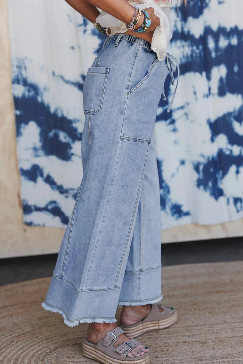 Beau Blue wide leg denim trousers with drawstring waist and raw hem detailing