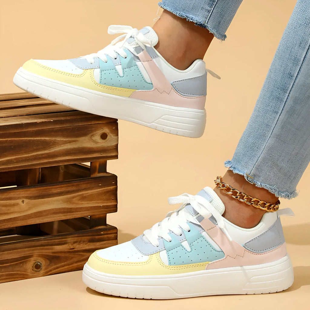 Trendy platform sneakers with white and yellow moon colour block, cross straps, and lace-up closure on a light background
