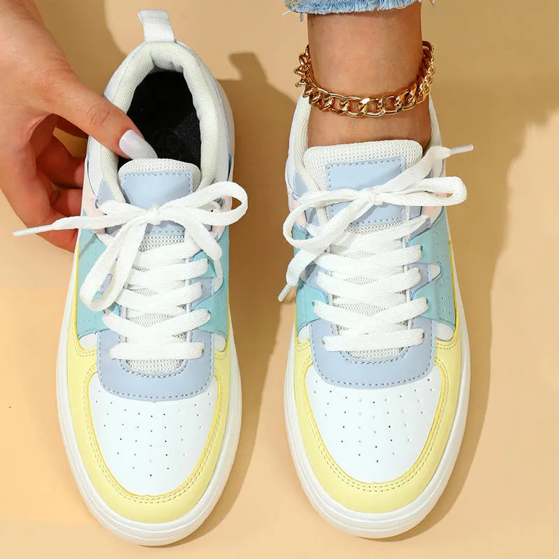 Trendy platform sneakers with white and yellow moon colour block, cross straps, and lace-up closure on a light background