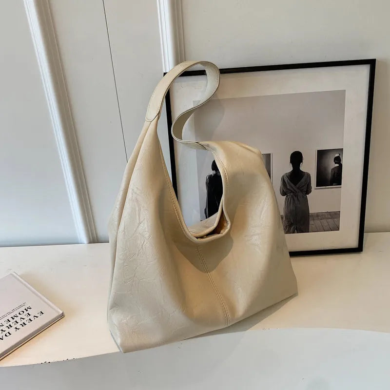 Soft PU leather casual shoulder bag with an adjustable strap, shown in a choice of colours.