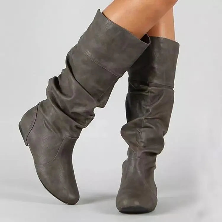 Women's black slip-on ankle boots with flat heel and round toe design