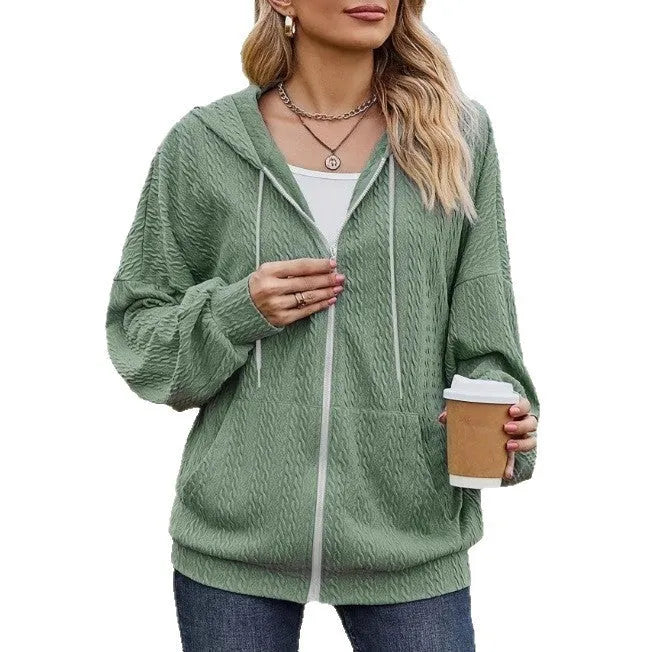 Green hooded zip-front sweatshirt coat on a hanger, showing loose fit and casual style.