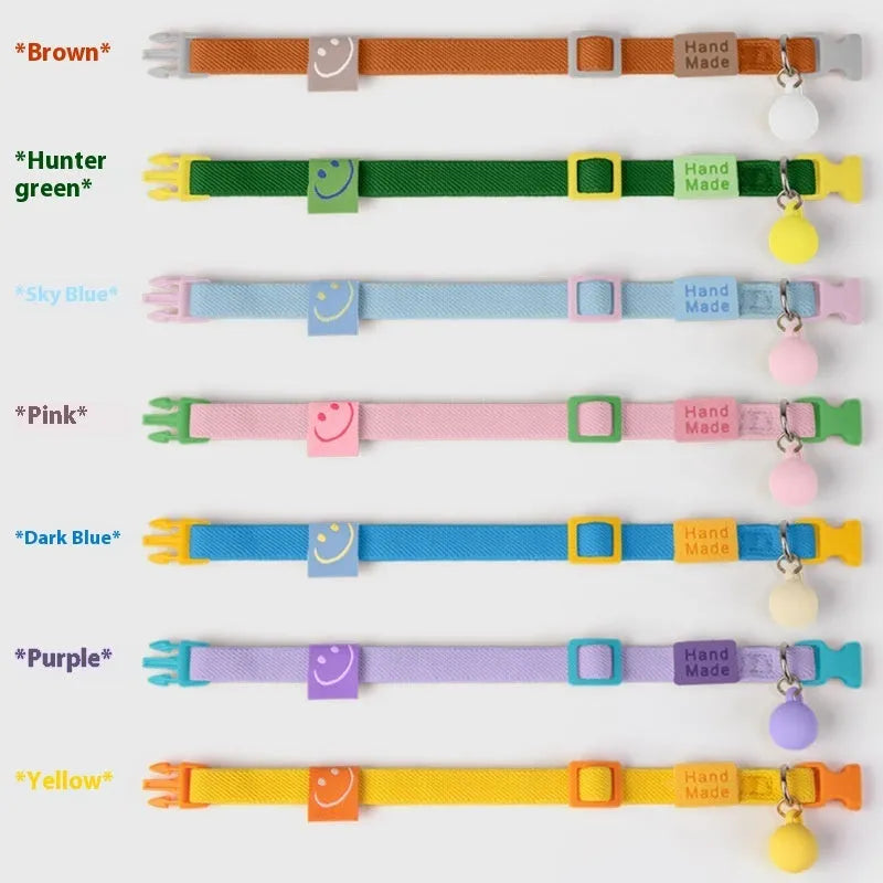 Small dog's elastic polyester collar in a solid colour with a buckle, showing the adjustable length.