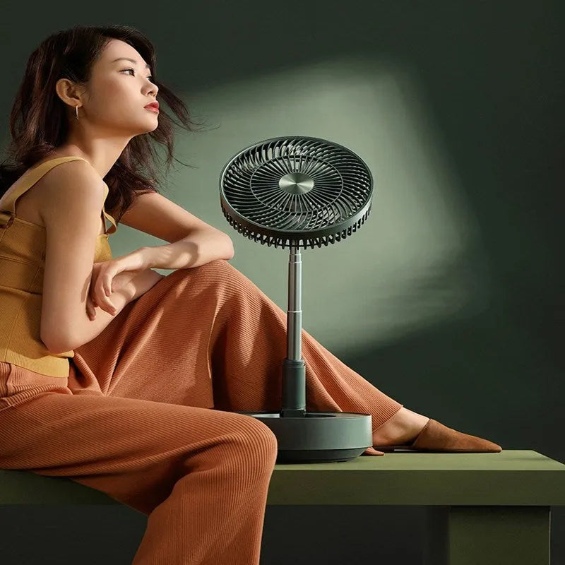 Green telescopic rechargeable floor fan extended to full height with remote control
