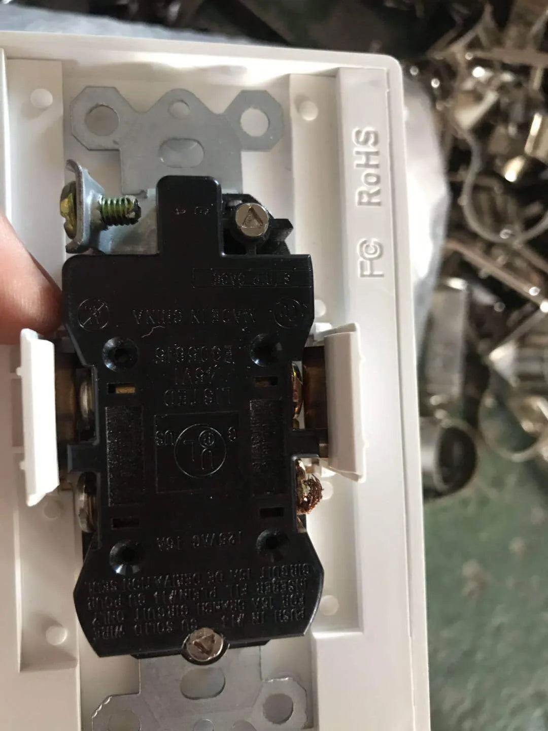 White automatic sensor LED night light plugged into a wall socket.