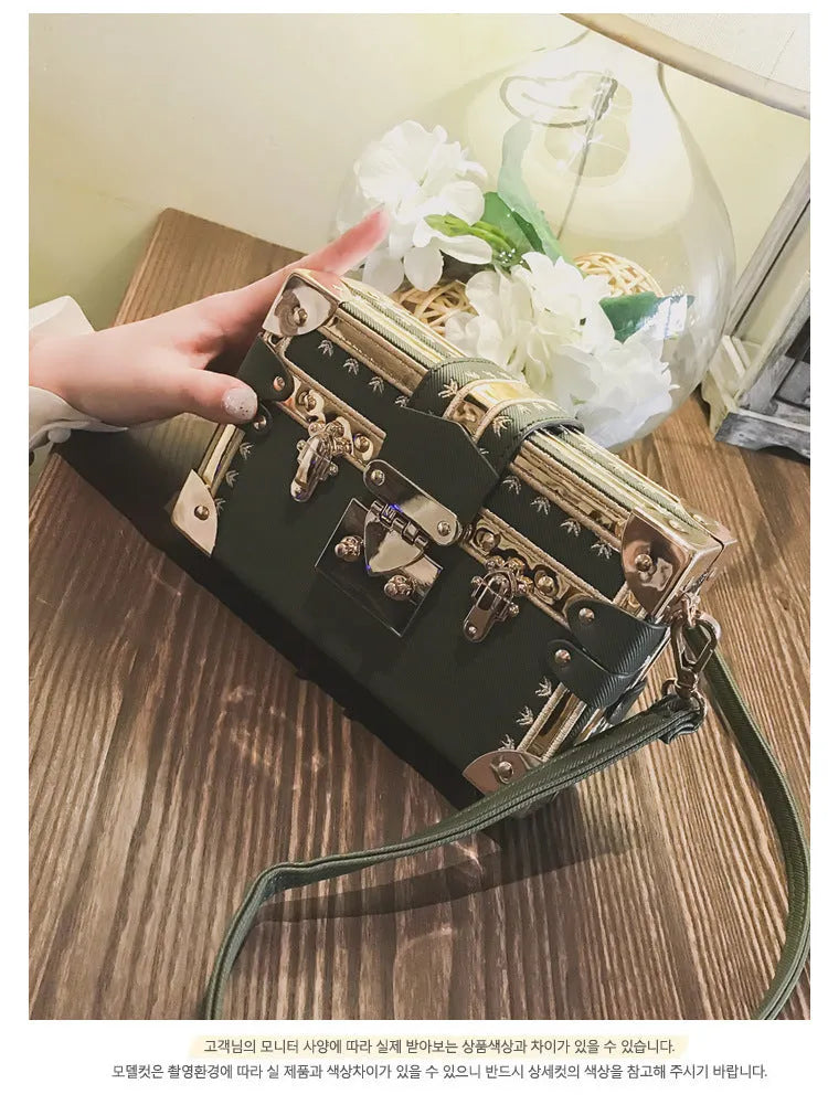 Women's black hard case shoulder bag with flap closure and single strap