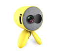 YG220 portable LED projector in white or yellow colour on a table projecting a movie scene.