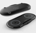 Black dual wireless charging pad charging two smartphones simultaneously on desk