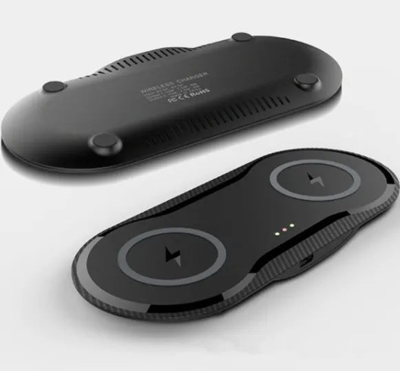 Black dual wireless charging pad charging two smartphones simultaneously on desk