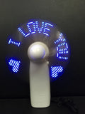 White handheld mini fan showing blue and red LED 'I Love You' pattern, held in hand.