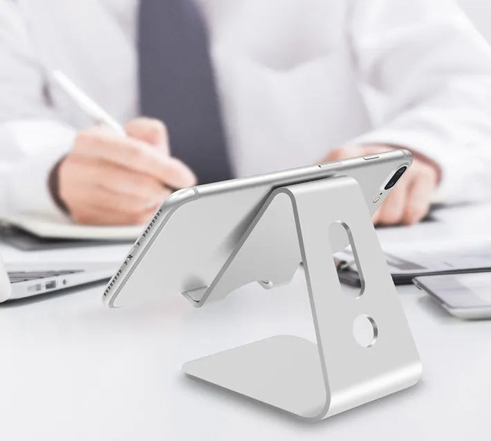 Aluminium alloy universal phone and tablet stand in silver colour on a desk