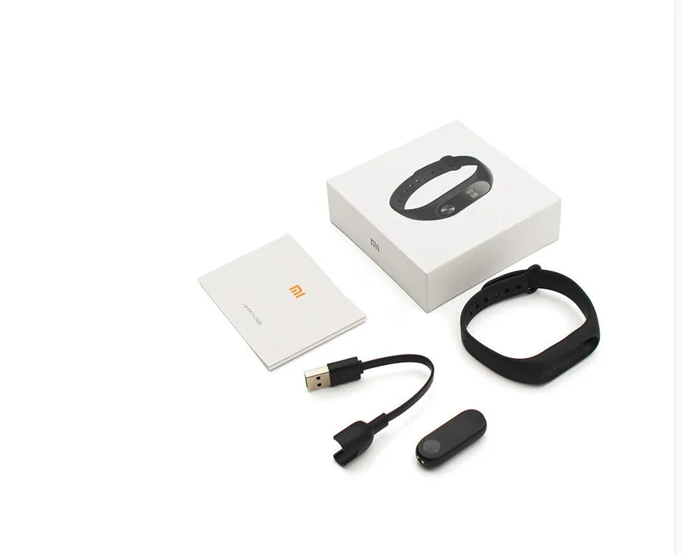 Xiaomi Mi Band 2 black fitness tracker on wrist showing OLED screen with heart rate data