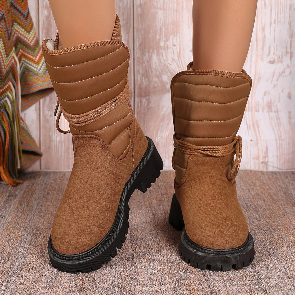Women's black suede chunky heel snow boots with lace-up design and high top.