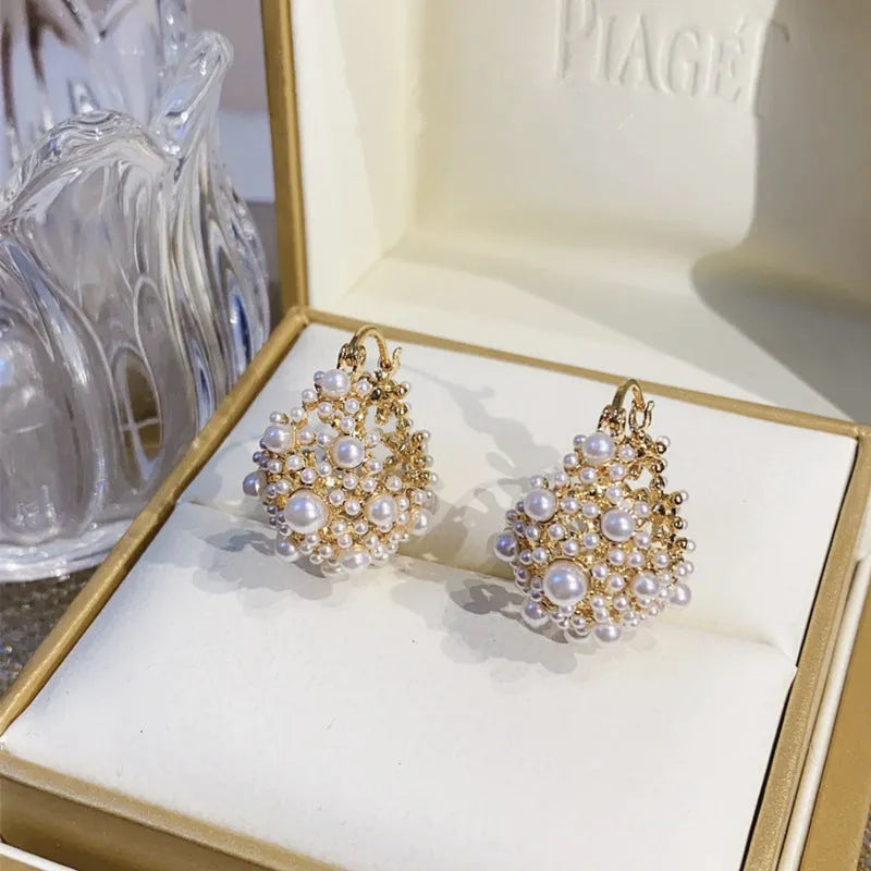 Gold-coloured copper flower basket earrings for women with small bead detailing and pearl inlay.