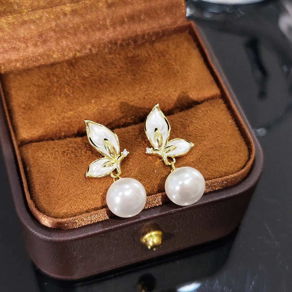 A pair of women's butterfly earrings in colour PT0203, made from copper with zircon painting.