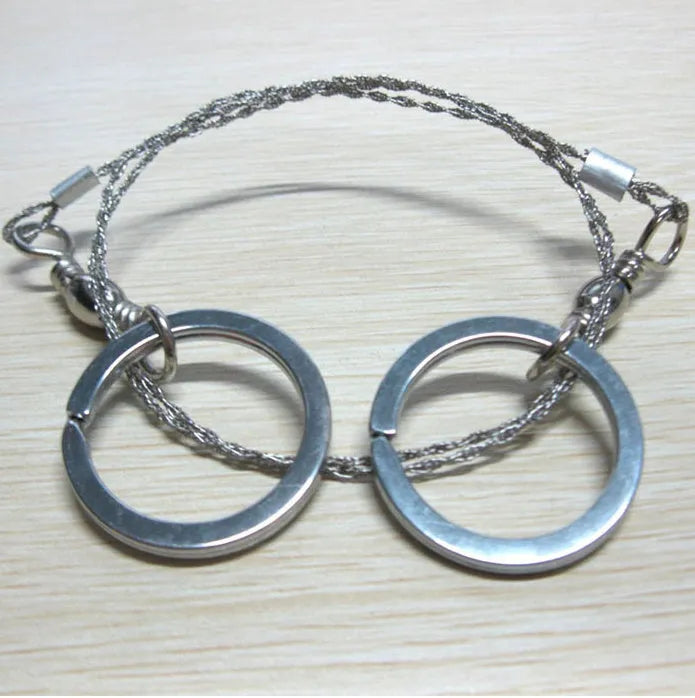 Stainless steel survival wire saw with pull rings, 55cm blade for outdoor wood cutting.