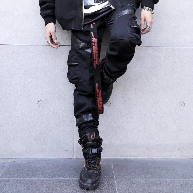 Black men's leather pocket splice cargo trousers with harem cut and long legs