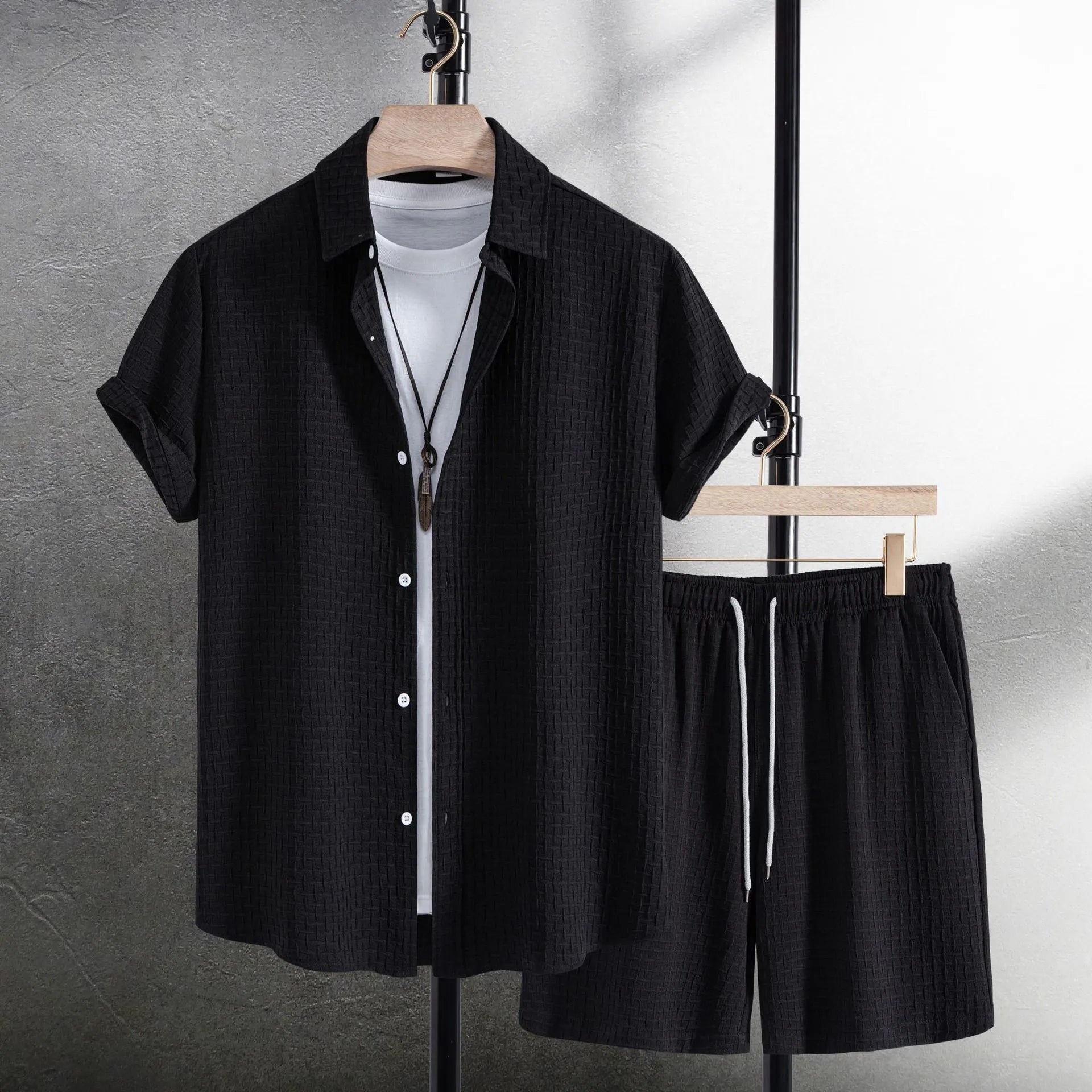 Men's loose cotton blend beach suit with short sleeve cardigan shirt and shorts in black.
