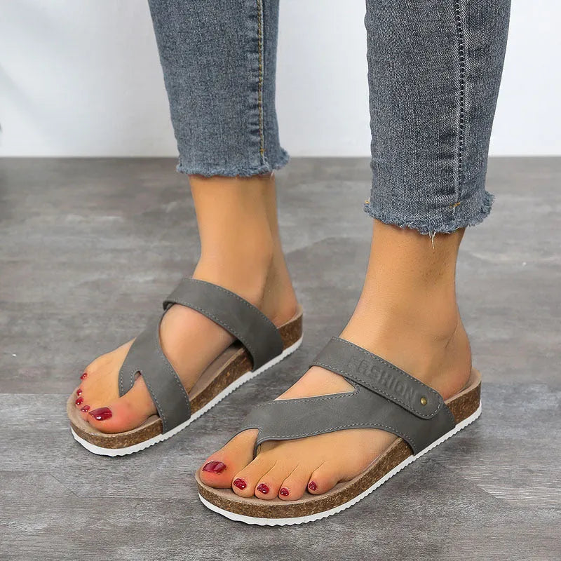 Women's blue flip-flops with a thick foam sole and a flat toe ring design on a solid colour artificial PU upper.