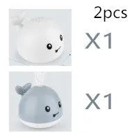 Electric whale bath toy with automatic water spray and flashing lights on a base