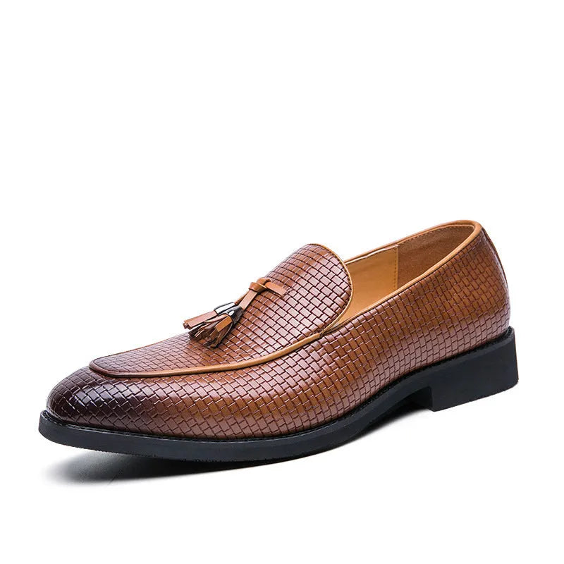 Men's black pointed toe slip-on business shoes with a tassel decoration on the front.