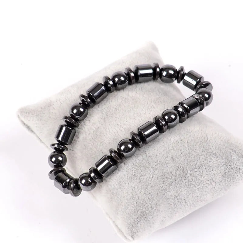 Black pentagram magnetic therapy bracelet with magnetite and hematite beads on wrist