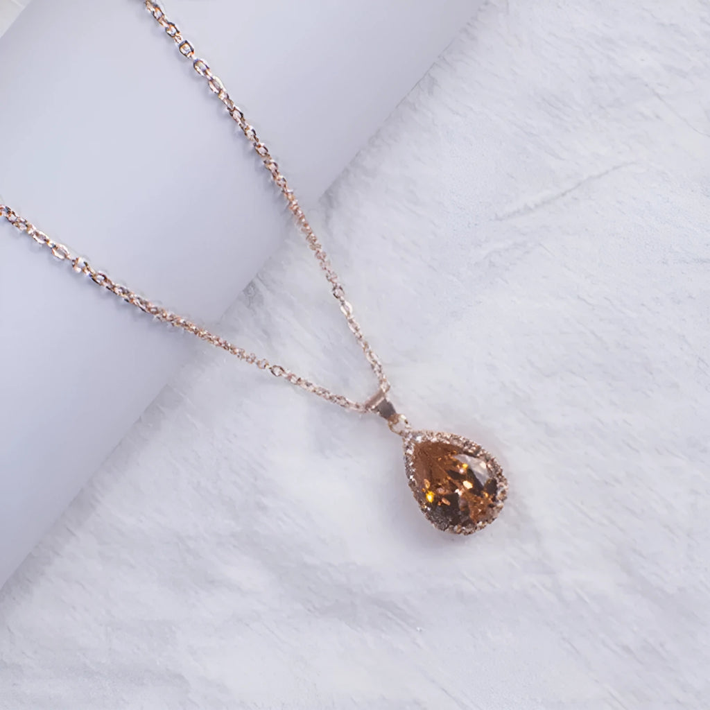 Women's alloy water drop necklace with rose gold electroplated colour and rhinestone inlays on a geometric pendant.