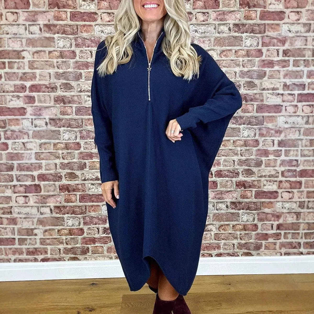 Women's solid colour knitted loose dress with front zip and raglan sleeves.