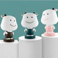 Cartoon animal table lamp in bear, cattle, rabbit, or tiger design with plastic shade and LED light