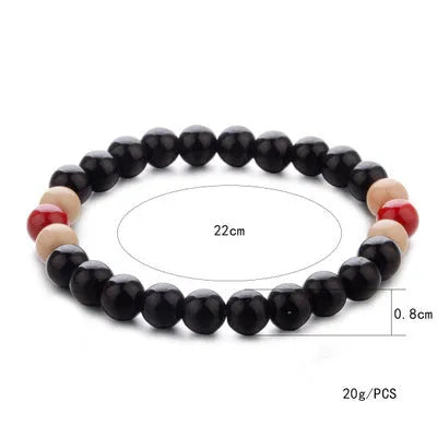 Unisex natural stone beaded bracelet with lava stones on a wrist, showing ethnic style design.