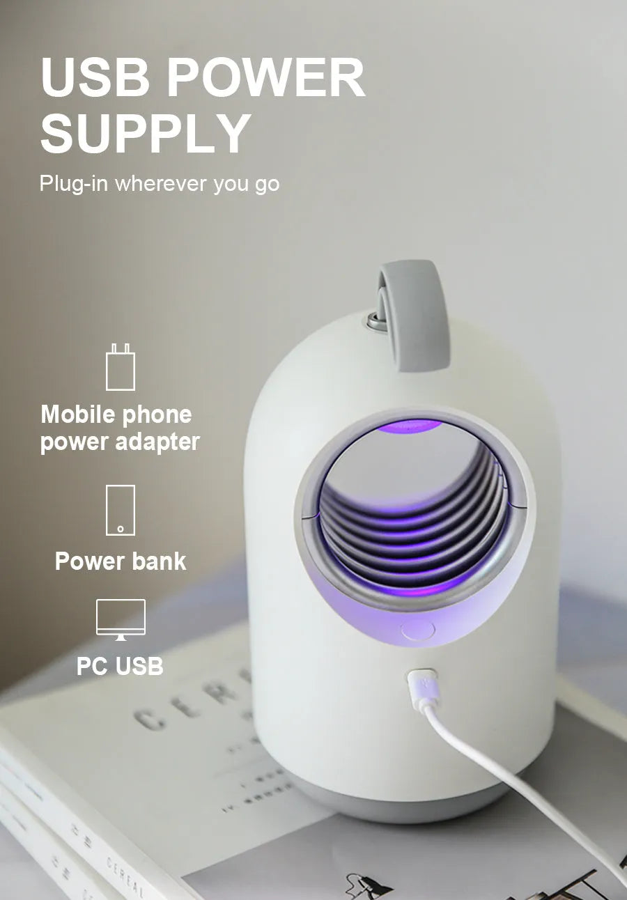 White and blue indoor mosquito killer lamp with UV light and carry handle on a table.