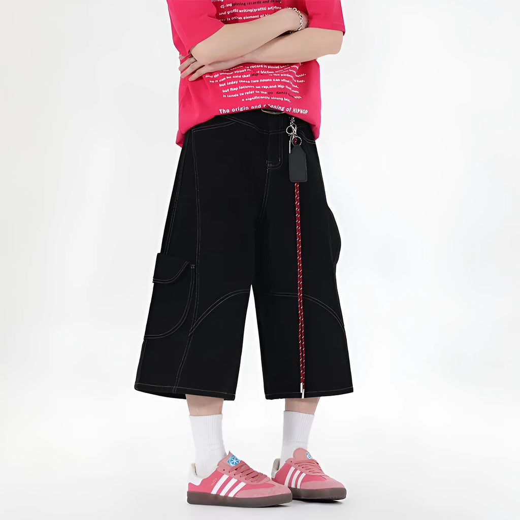 Retro black denim wide-leg shorts with multiple pockets on a mid-waist fit model.