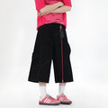Retro black denim wide-leg shorts with multiple pockets on a mid-waist fit model.