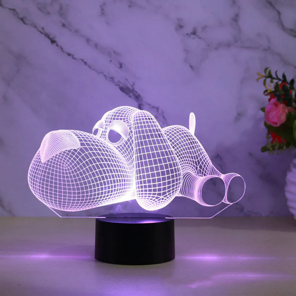 Glowing 3D illusion dog desktop night light showing multiple colour options on a desk.