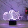 Glowing 3D illusion dog desktop night light showing multiple colour options on a desk.