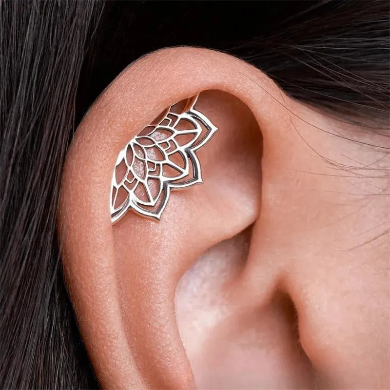 Spider web design stud earrings in gold and silver electroplated metal.